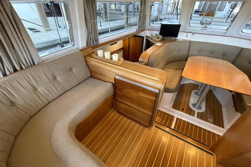 Slide: The Image of Interior of 2006 PDQ 34 Power Catamaran with cozy seating and wooden finishes. - 19
