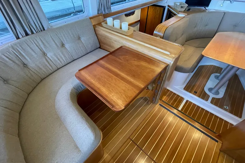 Slide: The Image of Interior of 2006 PDQ 34 Power Catamaran with wooden flooring and cozy seating area. - 20