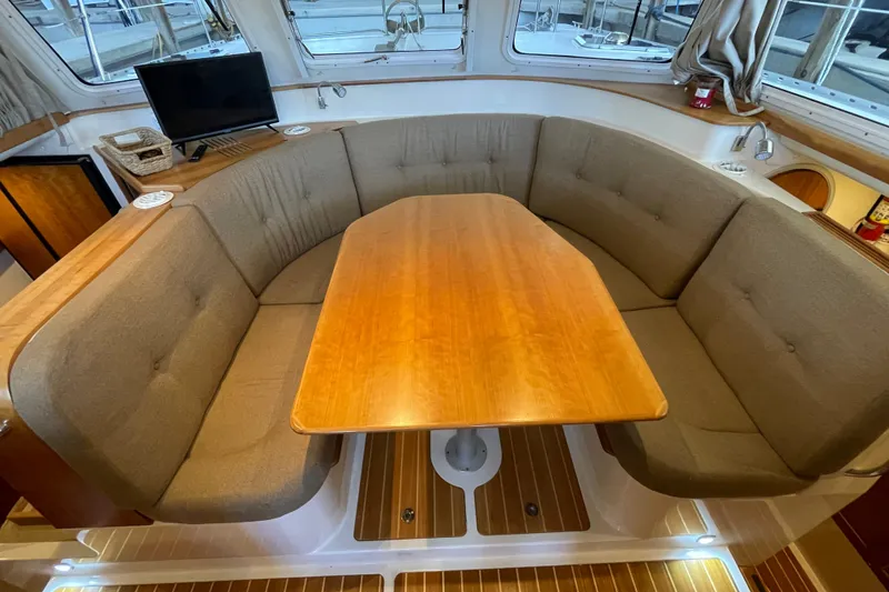 Slide: The Image of Interior of 2006 PDQ 34 Power Catamaran with cozy seating and wooden table. - 21