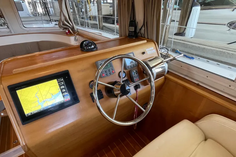Slide: The Image of 2006 PDQ 34 Power Catamaran helm with navigation screen and steering wheel. - 22