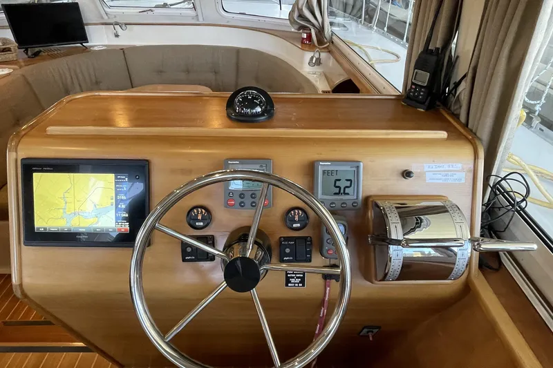 Slide: The Image of 2006 PDQ 34 Power Catamaran helm with navigation equipment and steering wheel. - 23