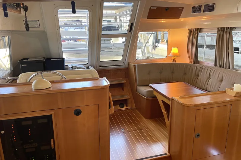 Slide: The Image of Interior of 2006 PDQ 34 Power Catamaran with wood finish and cozy seating area. - 25