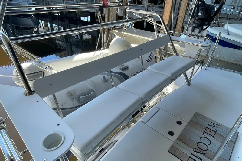 Slide: The Image of 2006 PDQ 34 Power Catamaran deck with seating and welcome mat. - 3