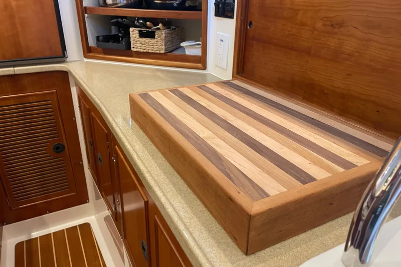 Slide: The Image of Kitchen area of 2006 PDQ 34 Power Catamaran with wooden cutting board. - 30