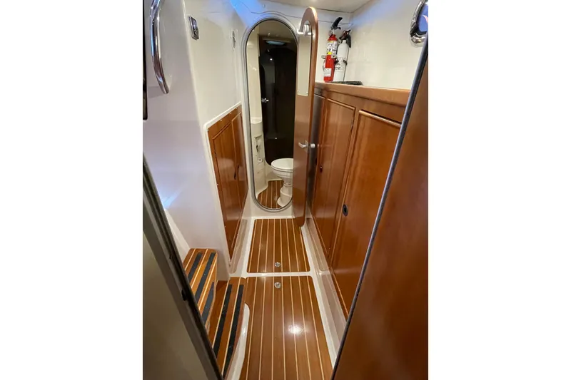 Slide: The Image of 2006 PDQ 34 Power Catamaran interior with wood paneling and compact bathroom. - 35