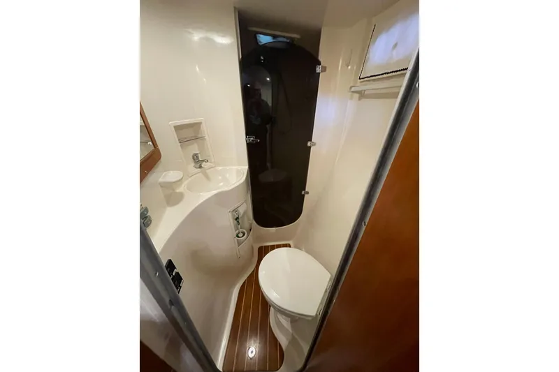 Slide: The Image of Compact bathroom in 2006 PDQ 34 Power Catamaran with sink, toilet, and shower. - 37