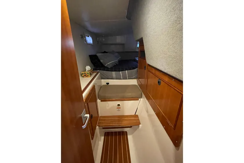 Slide: The Image of Interior cabin of 2006 PDQ 34 Power Catamaran with wooden accents and cozy bedding. - 38