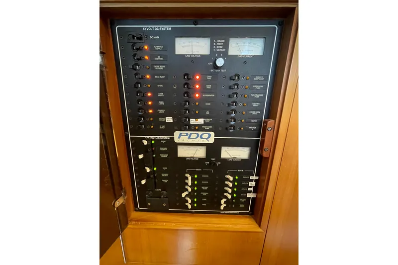 Slide: The Image of Electrical control panel on a 2006 PDQ 34 Power Catamaran, featuring various switches and gauges. - 40