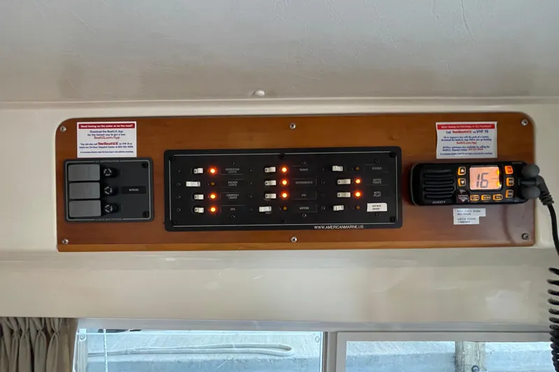 Slide: The Image of Control panel of 2006 PDQ 34 Power Catamaran with switches and radio display. - 41