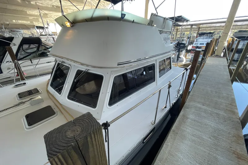 Slide: The Image of 2006 PDQ 34 Power Catamaran docked in a marina, showcasing its sleek design. - 6