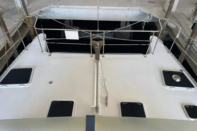 Slide: The Image of 2006 PDQ 34 Power Catamaran deck view with hatches and railing in marina. - 7