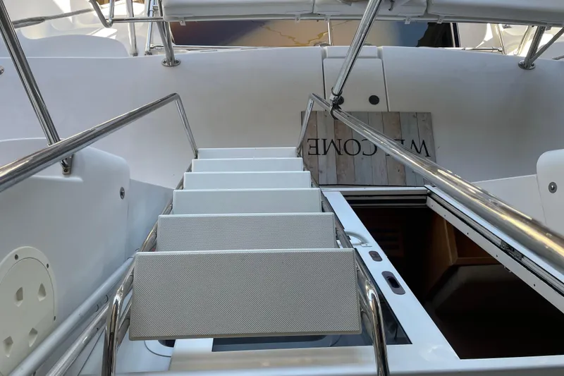Slide: The Image of Staircase on 2006 PDQ 34 Power Catamaran, leading to lower deck with welcome sign. - 8