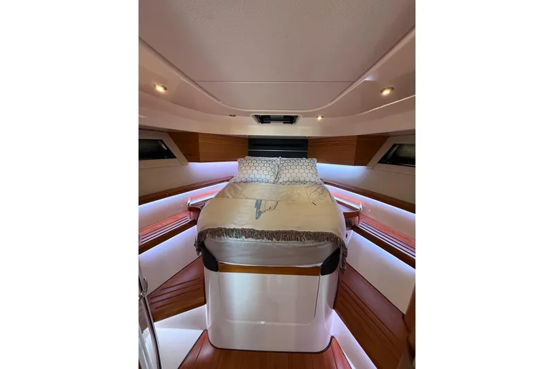 Slide: The Image of Luxurious cabin interior of 2024 Boston Whaler 405 Conquest with cozy bed and ambient lighting. - 10