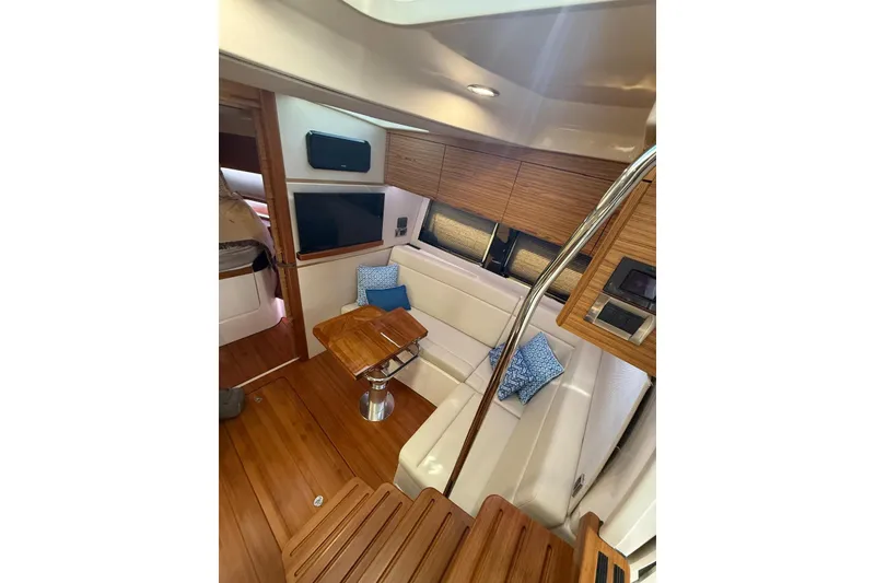 Slide: The Image of Luxurious interior of 2024 Boston Whaler 405 Conquest yacht with wood accents and seating. - 11
