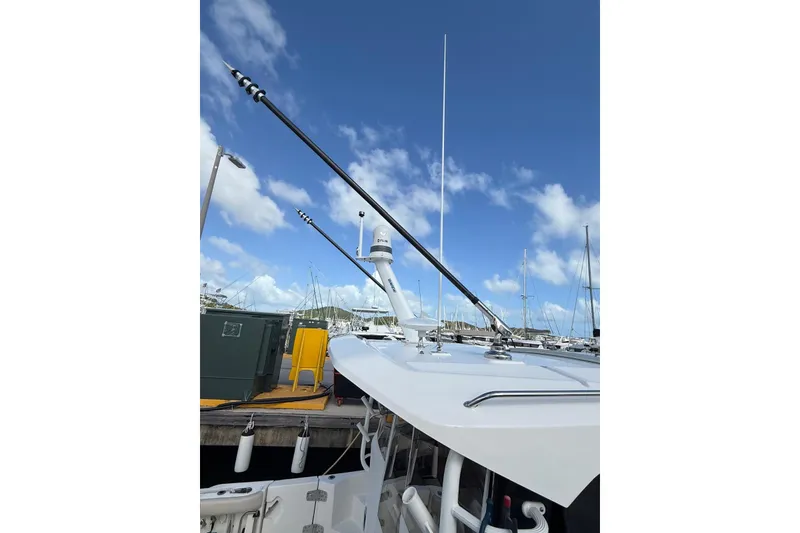 Slide: The Image of 2024 Boston Whaler 405 Conquest boat docked under clear blue sky. - 14