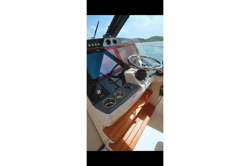 Slide: The Image of 2024 Boston Whaler 405 Conquest helm with modern controls and ocean view. - 3
