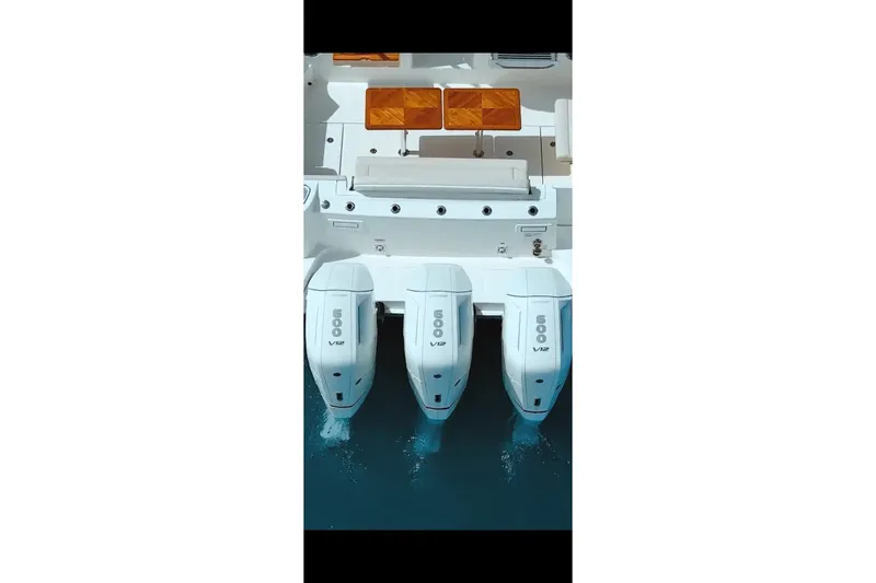 Slide: The Image of 2024 Boston Whaler 405 Conquest with triple V12 engines, viewed from above. - 5