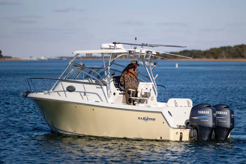 Slide: The Image of 2006 Sailfish 2660 WAC boat on water with dual Yamaha engines. - 10