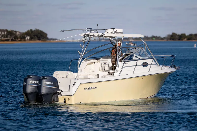 Slide: The Image of 2006 Sailfish 2660 WAC boat with dual Yamaha engines on calm water. - 12