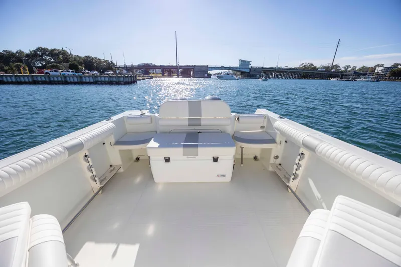 Slide: The Image of 2006 Sailfish 2660 WAC boat interior with seating, on a sunny day by the water. - 14