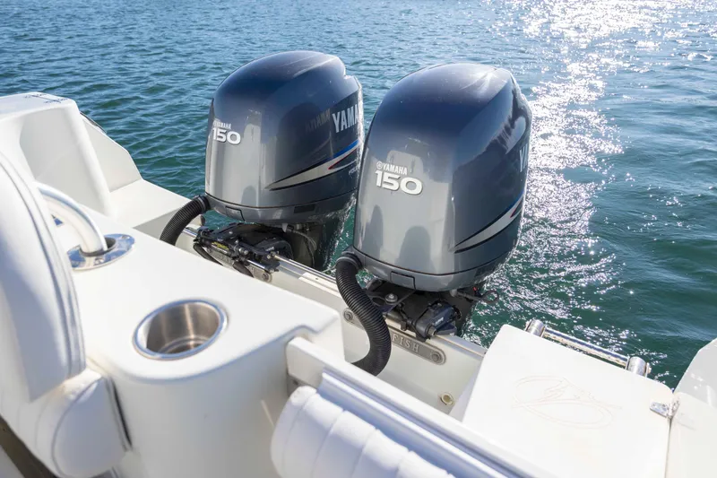 Slide: The Image of Twin Yamaha 150 engines on a 2006 Sailfish 2660 WAC boat in sparkling water. - 15