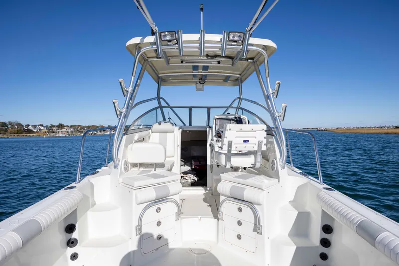 Slide: The Image of 2006 Sailfish 2660 WAC boat interior with seating, helm, and ocean view. - 16