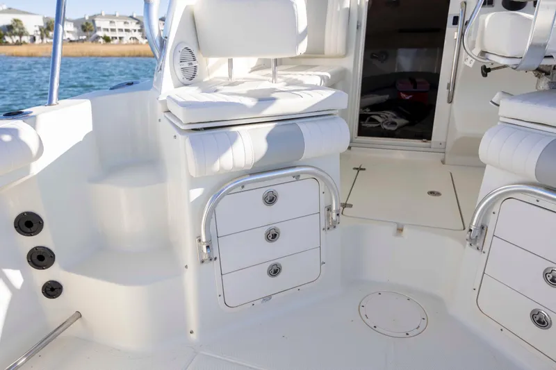 Slide: The Image of 2006 Sailfish 2660 WAC boat interior with white seating and storage compartments. - 20