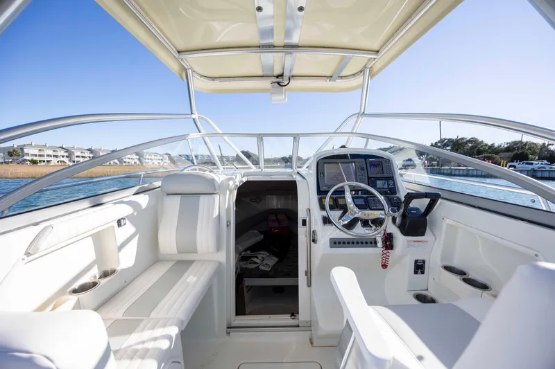 Slide: The Image of 2006 Sailfish 2660 WAC boat interior with steering wheel and navigation equipment. - 22