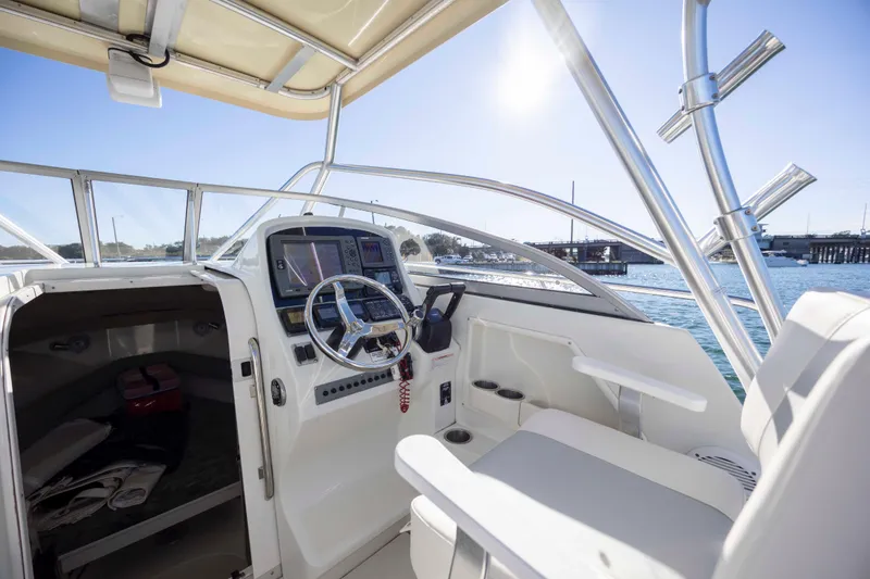 Slide: The Image of 2006 Sailfish 2660 WAC boat interior with steering wheel and cabin view. - 24