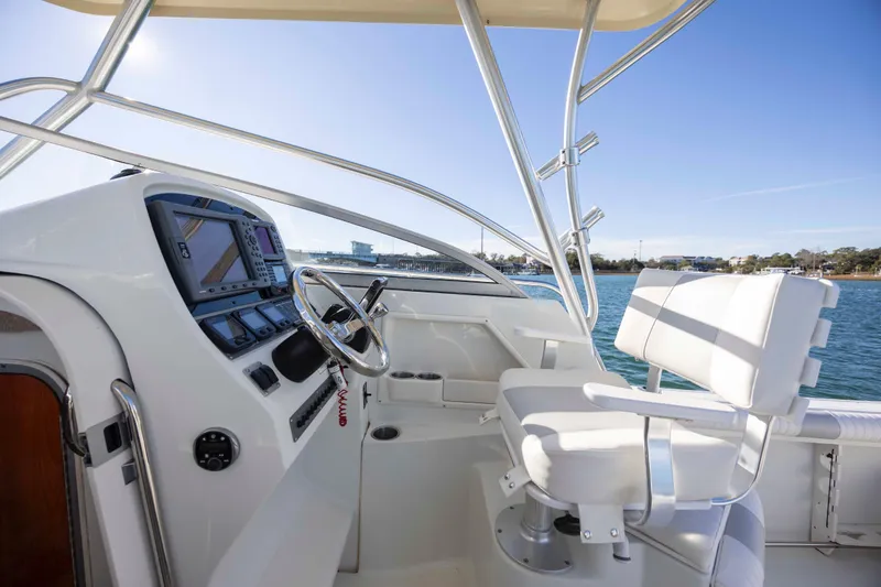 Slide: The Image of 2006 Sailfish 2660 WAC boat cockpit with steering wheel and navigation equipment. - 26