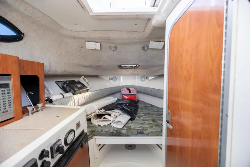 Slide: The Image of 2006 Sailfish 2660 WAC cabin interior with kitchenette and sleeping area. - 27