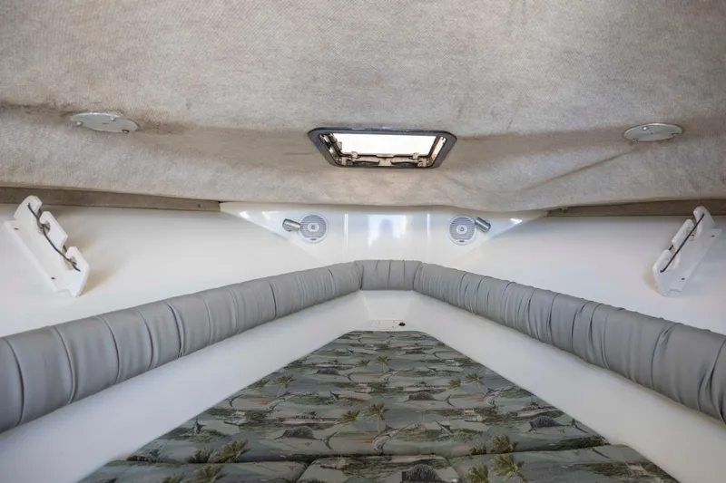 Slide: The Image of Interior cabin of 2006 Sailfish 2660 WAC boat with cushioned seating and hatch. - 33
