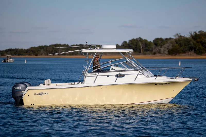 Slide: The Image of 2006 Sailfish 2660 WAC boat on calm water with Yamaha engine. - 5