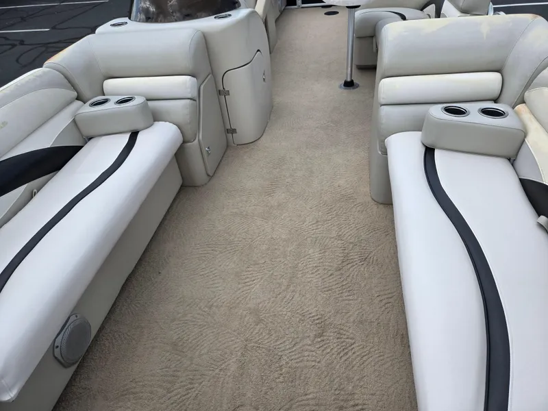 Slide: The Image of Luxurious seating on a 2012 Sweetwater 2486 boat with beige upholstery and cup holders. - 10