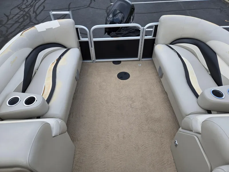 Slide: The Image of Interior of a 2012 Sweetwater 2486 pontoon boat with beige seating and carpet. - 16