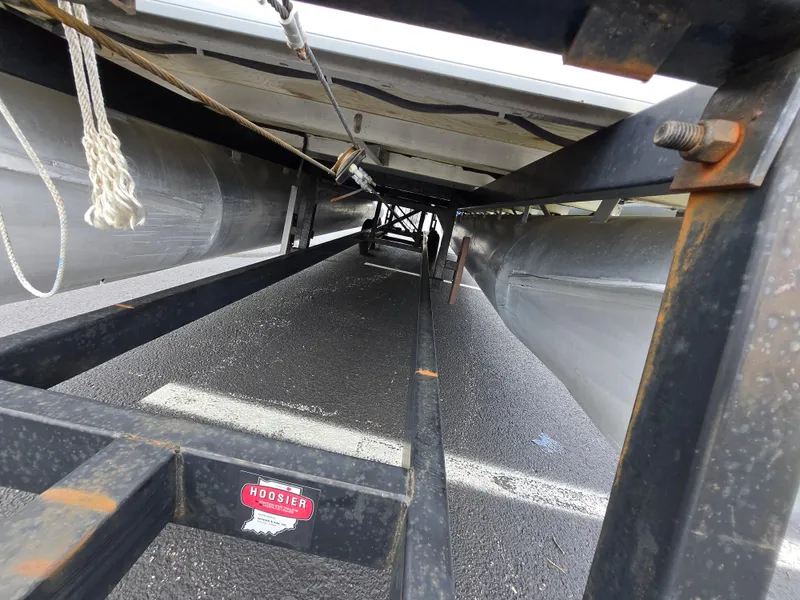 Slide: The Image of Underneath view of a 2012 Sweetwater 2486 pontoon boat on a trailer. - 7