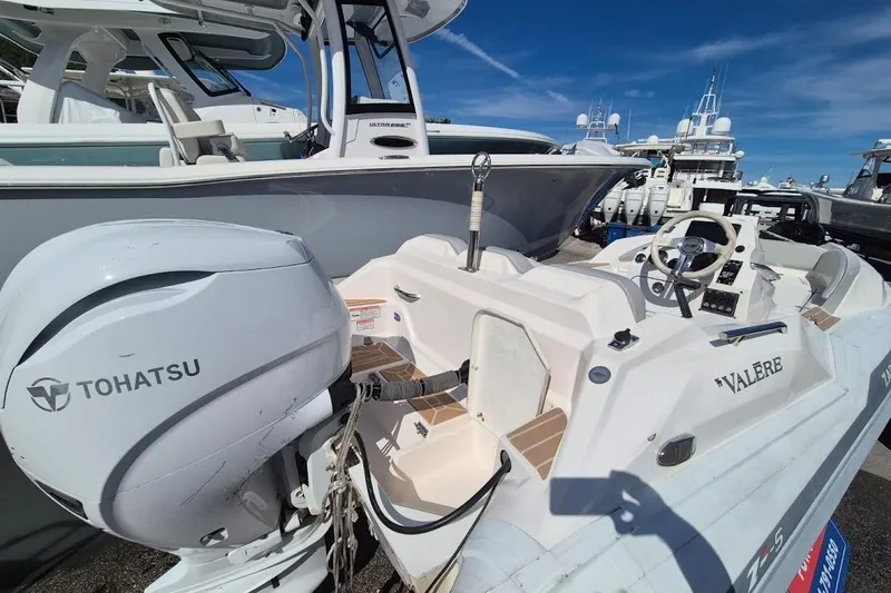 Slide: The Image of 2019 Zar Inflatable boat with Tohatsu engine, docked under clear blue sky. - 4