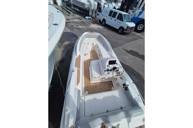Slide: The Image of 2019 Zar Inflatable boat with wooden deck, parked near white van. - 5