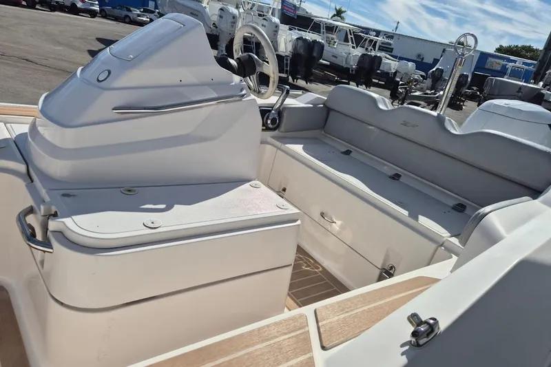 Slide: The Image of 2019 Zar Inflatable boat interior with steering console and seating, parked outdoors. - 6
