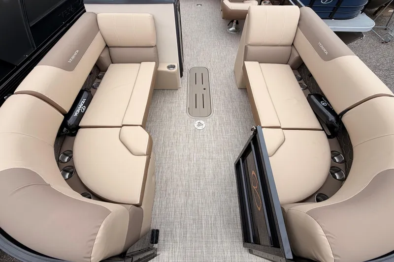 Slide: The Image of 2026 Veranda VR 235 L pontoon boat interior with beige seating and cup holders. - 4
