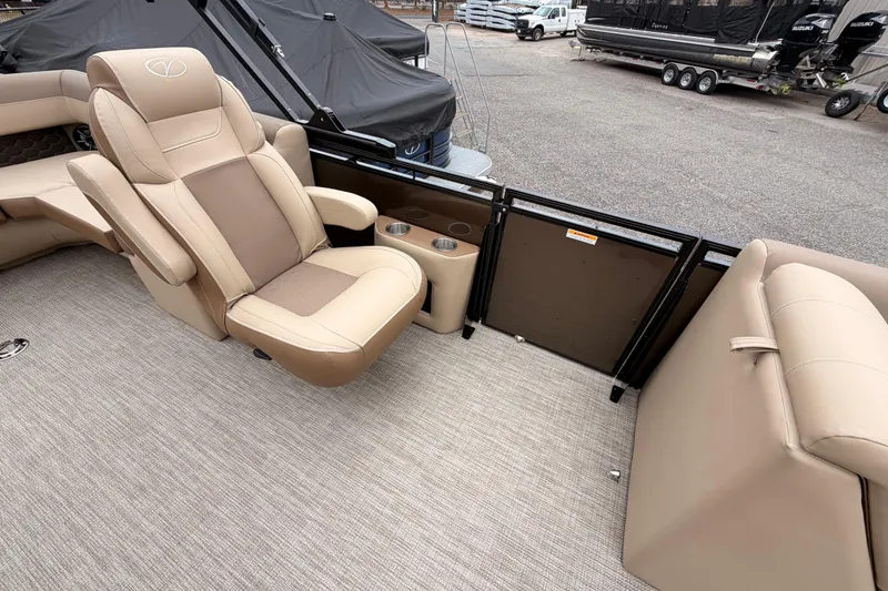 Slide: The Image of Luxurious seating on 2026 Veranda VR 235 L pontoon boat, featuring beige upholstery and cup holders. - 9