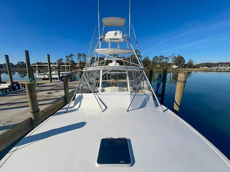 Slide: The Image of 1998 Jersey Cape 36 Express at dock, calm waters. - 14