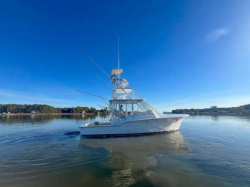 Slide: The Image of 1998 Jersey Cape 36 Express boat on calm water. - 20