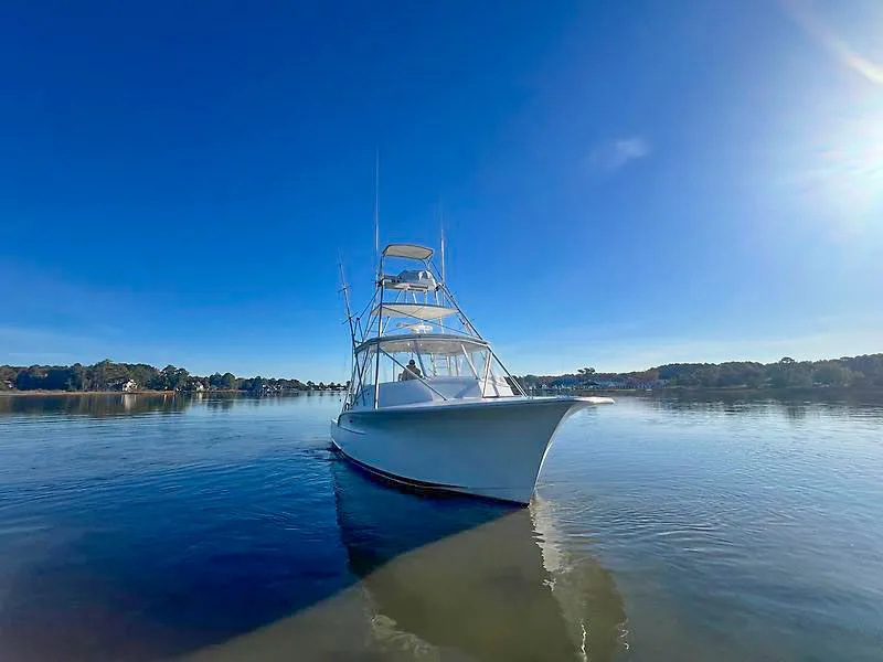 Slide: The Image of Jersey Cape 36 Express 1998 on calm water under sunny sky. - 21