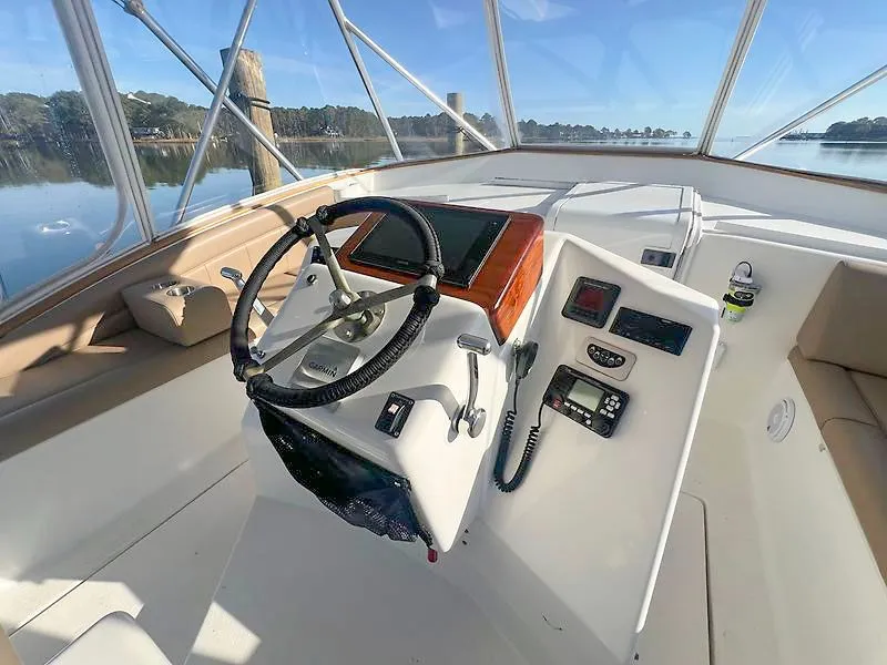 Slide: The Image of 1998 Jersey Cape 36 Express helm on calm waters. - 5