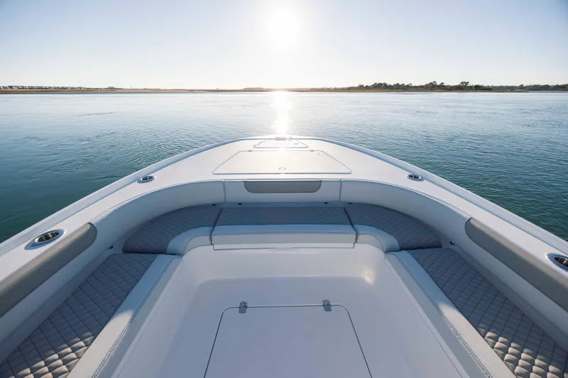 Slide: The Image of Caymas 26 HB 2026 boat on calm water at sunrise. - 10