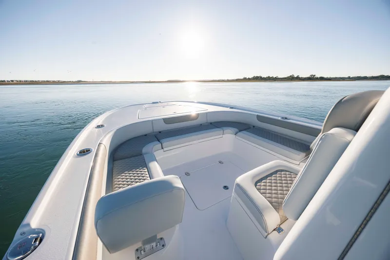 Slide: The Image of Luxurious Caymas 26 HB boat, 2026 model, on calm waters at sunset. - 11