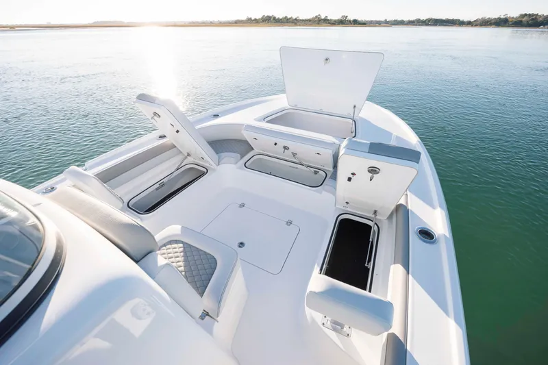 Slide: The Image of Caymas 26 HB 2026 boat with open storage on calm water. - 13