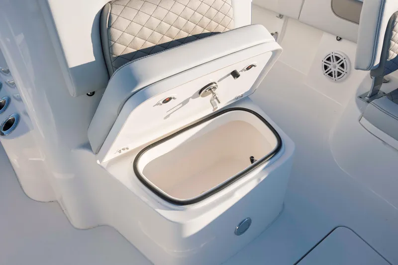 Slide: The Image of Caymas 26 HB 2026 boat with open storage compartment and cushioned seat. - 16