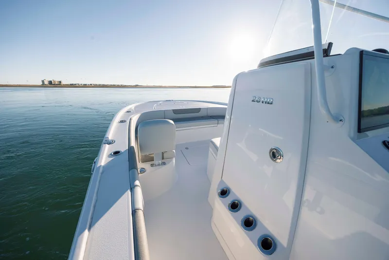 Slide: The Image of Caymas 26 HB 2026 boat on calm water at sunrise. - 17